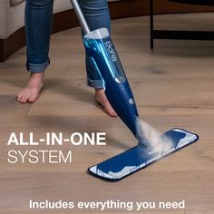 a woman is cleaning the floor with an all in one system vacuum and mop