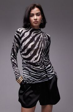 A bold zebra print ensures a head-turning look in this funnel-neck top made from crinkled woven fabric. 24 1/2" length (size Medium) Funnel neck Long sleeves 100% polyester Machine wash, line dry Imported Spring Zebra Print Tops, Spring Zebra Print Stretch Top, Spring Stretch Zebra Print Top, Black Zebra Print Party Top, Black Zebra Print Top For Workwear, High Neck Long Sleeve Top, Winter Party Dress, High Neck Top, High Neck Long Sleeve