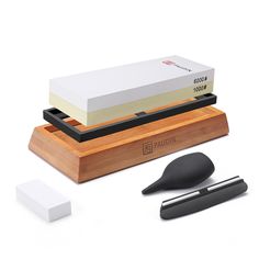 an electronic device is sitting on top of a wooden stand next to other electronics and accessories