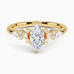 a yellow gold engagement ring with an oval cut diamond surrounded by smaller round brilliant diamonds