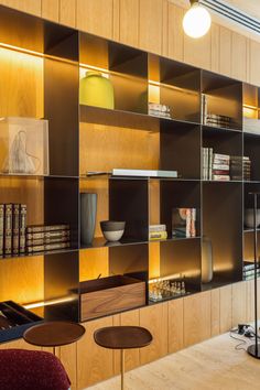 a room with wooden shelves and chairs in it