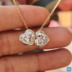 Handcrafted Elegance for Every Day: Dive into the world of bespoke jewelry with our Twin Stone Heart Shaped Pendant, meticulously handcrafted for the modern woman. Whether it's a day at the office or a night on the town, this piece is your new go-to. Moissanite Magic: Delight in the dazzling sparkle of 4-carat moissanite. Set in a sophisticated bezel, this pendant promises brilliance that mirrors diamonds. 14kt Yellow Gold Luxe: Immerse yourself in the timeless allure of 14kt yellow gold. It's n Luxury Bezel-set Heart Cut Jewelry, Luxury Bezel Set Jewelry For Valentine's Day, Luxury Jewelry With Bezel Setting For Valentine's Day, Luxury Heart Cut Bezel Set Jewelry, Luxury Heart-shaped Jewelry With Bezel Setting, Heart Cut Moissanite Jewelry With Brilliant Cut, Heart Cut Brilliant Moissanite Jewelry, Fine Jewelry Gia Certified Heart-shaped, Moissanite Jewelry For Anniversary On Valentine's Day