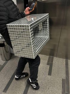 a person with a cell phone in a cage