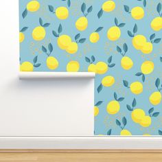 a blue wall with yellow lemons on it