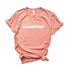 Looking for a cute versatile top to wear this summer? Make sure to grab one of our Be The Sunshine tees! This soft and comfortable graphic tee is the perfect top for any outfit. It can be paired with biker shorts, jeans, or even a simple skirt/dress! This tee is true-to-size, so be sure to order your regular t-shirt size! If you are looking for a more oversized look, make sure to size up! Summer Basic Shirt With Graphic Print, Comfortable Fit T-shirt With Text Print For Summer, Summer Everyday Tops With Letter Print, Basic Graphic Print Summer T-shirt, Summer Tops With Letter Print For Everyday, Summer Letter Print Tops For Everyday, Basic Summer T-shirt With Graphic Print, Basic Graphic Print T-shirt For Summer, Comfortable Summer T-shirt With Graphic Print