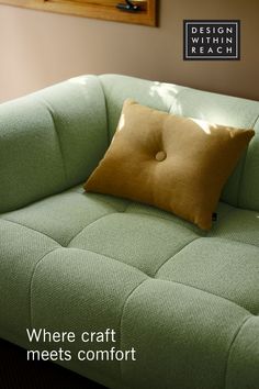 modern green sofa designed for hay with yellow throw pillow on top