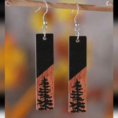 the earrings are made from wood and have pine trees on them