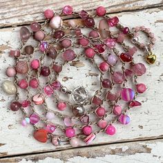 "Handmade PINK Crochet Beaded Wrap Bracelet & Necklace ~ ALL IN ONE!  Loaded with a mixture of semiprecious stones and reflective glass beads. Secured with a faceted crystal clear glass bauble which can be worn in the front or back. This handmade Boho necklace can ALSO be wrapped FIVE times around your wrist for an effortlessly layered WRAP BRACELET. (ANKLETS are not out of the question either, give it a try!) I promise it will quickly become a favorite no matter the occasion, no matter the seas Pink Hand-wrapped Necklace For Jewelry Making, Handmade Spiritual Pink Beaded Necklaces, Handmade Pink Spiritual Beaded Necklace, Pink Bohemian Lariat Jewelry, Bohemian Pink Lariat Jewelry, Adjustable Pink Beaded Bracelets With Natural Stones, Spiritual Pink Beaded Necklaces For Jewelry Making, Pink Heart Beads For Jewelry Making, Bohemian Pink Necklace With Heart Beads