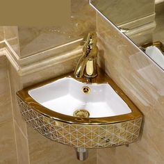 a gold and white sink in a bathroom