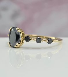 Everyday Wear Amazing Handmade Black Gold Ring For Her. 1 Carat Oval Black Gem Amazing Handmade Gold Ring For Her Black Gold Ring, ring For Her, Amazing gold ring, Handmade ring. Setting Options (Choose & Checkout) White, Rose or Yellow Gold 14k or 18k 4-14 US for your choice Center Stone: Oval Cut 7.50 x 5.50 mm Carat weight: 1.01 ct Color: Black Clarity: AAA Cut: Excellent Natural Spinel Setting: 4 Prongs Gemological Certificate  Side Stone: 6 Diamonds Carat weight:: 0.18 ct Color: Black Clarity: AAA Cut: Excellent Band Details: 1.50 mm thickness: 1.40 mm width Why ∙ It's ∙ Awesome ✓ Gemological Certificate  ✓ 20 Years of Experience ✓ 100% Original Designs ✓ Conflict-Free Diamonds & Gemstones ✓ Free USA Shipping ✓ Custom Orders ✓ Contact us for special request Easy Payment Option: You ca Black Stone Rings, Handmade Gold Ring, Black Gold Ring, Black Stone Ring, Black Gems, Black Diamond Ring, Shape Art, Ring Oval, Handmade Gold