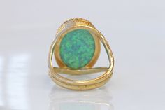 GREEN OPAL RING, Opal Gold Ring, Gemstone ring, October Birthstone, Opal Emerald lawn Gold Filled Ring, Fire Opal jewelry, Opal Big Ring Statement green opal ring made of 14k gold filled the stone is 13*18 mm , it is a perfect to give as a gift for woman Measurements: Size- available all size The center stone is 18mmx13mm Gemstone is a lab opal The ring will be packed in a gift box. FOR MY RINGS COLLECTION HERE: https://www.etsy.com/il-en/shop/rebekajewelry?section_id=14282915&ref=shopsectio Unique Green Emerald Ring With Gemstone Accents, Green Oval Opal Ring For Formal Occasions, Green Opal Cabochon Ring, Green Opal Ring For Anniversary, Fine Jewelry Green Opal Ring, Hallmarked Green Opal Ring In Fine Jewelry Style, Green Opal Wedding Jewelry, Anniversary Green Opal Ring, Green Opal Open Ring Gift