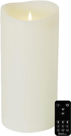 a white candle next to a remote control for an appliance or lighting device