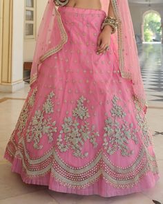 COLOR : Shimmering Blush Pink FABRIC : Top (Blouse) - Soft Net, Bottom (Lehenga) - Soft Net, Dupatta - Soft Net WORK : Heavy Metallic Thread Embroidery, Zari Work, Cutwork, Sequins, Motifs, Lace Border OCCASION : Wedding, Reception, Sangeet, Engagement READY-TO-WEAR : NoSTITCHING : Available as semi-stitched fabric, can be stitched using standard size option (+$30). Note: There might be a slight color variation due to lighting and flash used during photoshoot. The bright shade seen is the best c Embroidered Gown For Wedding Eid, Embroidered Gown For Wedding On Eid, Embroidered Gown For Wedding And Eid, Embroidered Wedding Gown For Eid, Art Silk Gown With Pallu For Reception, Dori Work Dresses For Eid Reception, Reception Dresses With Dori Work For Eid, Dori Work Dresses For Reception At Eid, Eid Reception Dresses With Dori Work