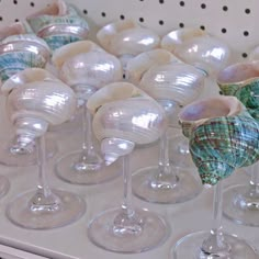 there are many wine glasses on the shelf