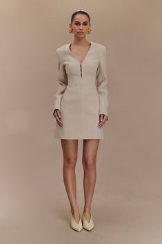 Sculpted sophistication. The ARORA Suiting Blazer Dress with Pleating effortlessly blends sophistication and modern style. Its flattering V neckline, complemented by a chic hook & eye neck detail, creates an elegant look that’s perfect for any occasion. Structured shoulders enhance the tailored silhouette, while the mini length adds a playful edge. The centre back zip ensures a sleek fit, and the fully lined interior provides comfort and quality. Whether dressed up or down, this dress is a versa Chic Sheath V-neck Dress For Formal Occasions, Chic Structured Mini Dress For Cocktail, Elegant Fitted V-neck Dress With Flattering Silhouette, Elegant Structured Mini Dress, Elegant Office Blazer Dress With Structured Boning, Chic Structured Dress With Boning, Elegant Fitted V-neck Semi-formal Dress, Elegant Fitted V-neck Dress For Semi-formal Occasions, Elegant Mini Length V-neck Dress For Formal Occasions