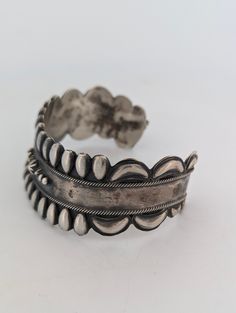 Celebrate the rich heritage of Native American craftsmanship with this vintage sterling silver cuff bracelet, a handmade treasure that exudes both strength and beauty. Stamped with a distinctive bear symbol and "RB", along with the .925 sterling silver mark, this piece is a stunning example of artistry and tradition. The repousse style design, enhanced by hand-stamped details and twisted wire accents, makes this bracelet a standout in any collection. Material: Authentic .925 sterling silver, guaranteeing high quality and durability. Design: Features a repousse style design with intricate hand-stamped details and twisted wire accents for added texture and dimension. Stamping: Bears a unique bear stamp with "RB" inside, a mark of Native American craftsmanship, alongside the .925 stamp for st Bear Symbol, Twisted Wire, Sterling Silver Cuff Bracelet, Sterling Silver Cuff, Silver Cuff Bracelet, Native American Jewelry, Silver Cuff, Vintage Accessories, Vintage Sterling Silver