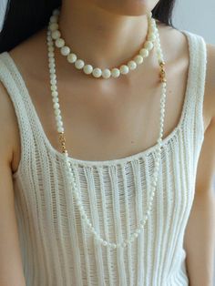 This elegant necklace showcases simplicity at its finest, featuring smooth white shell beads delicately strung together. The minimalist design exudes a timeless charm, perfect for both casual and formal occasions. With its versatile style, this necklace effortlessly complements any outfit, adding a touch of sophistication to your look. Metal: 18K Recycled Gold Plated On Brass Gemstone: Mother of Pearls(6.5mm/8mm/12mm) 6.5mm/8mm Bead Chain Length: 400mm 12mm Bead Chain Length: 390mm Weight: 26.5/ White Pearl Layering Necklaces, White Pearl Drop Necklace For Layering, Elegant Pearl Necklace For Layering With Round Beads, Elegant Pearl Necklace For Layering, White Pearl Beaded Necklaces For Layering, White Pearl Pendant Necklace For Layering, White Pearl Chain Necklace For Layering, White Pearl Necklace For Layering, Elegant Pearl Shell Necklace With Round Beads