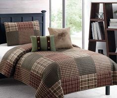 a bed with plaid comforter and pillows in a room next to a bookcase