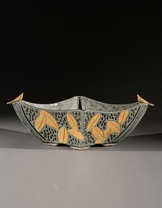 a decorative bowl with two birds on it