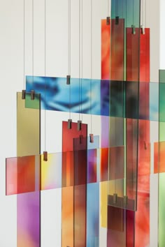 an abstract art piece hanging from the ceiling with colorful squares and rectangles on it