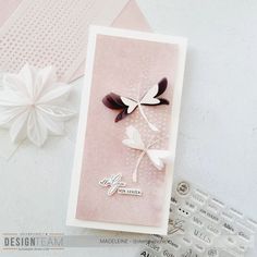 a close up of a greeting card on a table with paper flowers and other crafting supplies