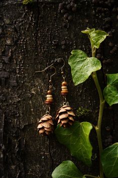 Nature jewelry lovers watch out! The forest jewelry collection is expanded with new pine cone earrings. These beautiful wooden earrings are studded with real pine cones, collected in the Black Forest in southern Germany, and will delight any hippie or boho lover. The handmade wooden jewelry pieces are a perfect gift for the nature jewelry lover. Each earring has been carefully crafted from natural materials, making them one-of-a-kind. Wear a piece of the forest on your ears with a pair of fir earrings and show your love for nature. These ethnic earrings are versatile enough to be worn with a variety of outfits. Explore our collection of fir earrings and wooden jewelry and find the piece of jewelry that enhances your personality. Treat yourself or a loved one to something special that is gu Handmade Nature-inspired Natural Jewelry, Handmade Natural Earrings With Nature-inspired Style, Forest Jewelry, Pine Cone Jewelry Diy, Natural Wood Nature-inspired Jewelry, Pine Needle Earrings, Pine Cone Earrings, Nature-inspired Drop Earrings With Natural Inclusions, Adjustable Wood Jewelry Nature-inspired