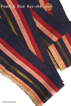 two scarves with different colors and patterns on the top one is red, blue, and gold