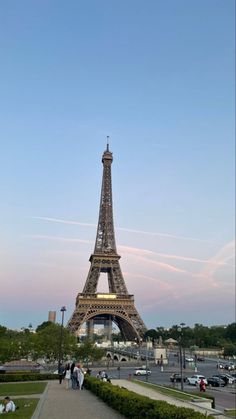 the eiffel tower in paris is very tall and has many people walking around it