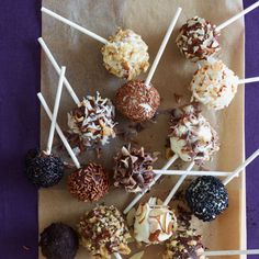 chocolate covered candies and marshmallows arranged on a brown paper bag with purple background