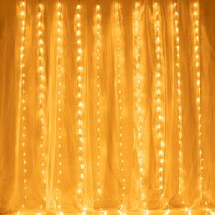 the curtain is covered with lights in yellow