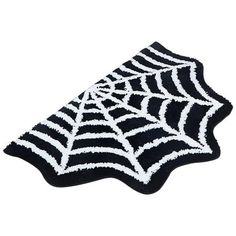 a black and white rug with spider webs on it's side, in front of a white background