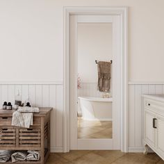 a bathroom with a sink, mirror and bathtub next to a wooden cabinet in the corner