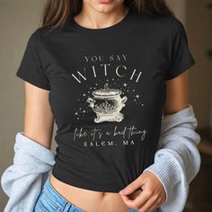 Get ready to be OBSESSED with your new witch baby tee! It's the cutest and most trendy way to emit all those witchy vibes! Great as a gift! * S I Z I N G * ✺ Shirt is a Gildan5000B youth size ✺ Fits like a traditional 90's style baby tee ✺ Check size guide graphic for fit * S H I P P I N G * T I M E S * ✺ Our items are individually made with love for each of our buyers. Because of this, our processing time is 2-5 business days (depending on order volume) plus transit time, but typically much faster. We know our customers want their items as quickly as possible! * K E E P * S H O P P I N G *   ✺ Shop our entire collection here:  https://www.etsy.com/shop/MoonGoddessApparel EXCHANGES: Because all of our items are custom and made to order, our policy is exchange only. In the event that you'd Fitted Gothic T-shirt For Fall, Gothic Crew Neck Top With Letter Print, Gothic Short Sleeve Top With Letter Print, Witchy Short Sleeve Cotton Tops, Witchy Cotton Short Sleeve Tops, Spooky Fitted Graphic Print Tops, Fitted Cotton Spooky T-shirt, Fitted Short Sleeve Spooky T-shirt, Fitted Spooky Graphic Print Top