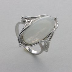 These is a beautiful Sterling Silver Ring with a Rainbow Moonstone Gemstone. The ring are made out of solid 925 Silver and there is no nickel or other substances causing most allergies. This makes the ring hypo allergenic. Size of the Moonstone 2.0 x 1.0 cm or  0.79 x 0.39 inch Please note: Our jewelry is photographed close up to show detail and may appear larger than they are. . We use a dime coin as size reference on one of the pictures. You will receive the item in a gift box - perfect to sur Elegant Opal Ring With Large Round Stone, Anniversary Jewelry With Large Moonstone, Anniversary Silver Moonstone Ring With Stone Setting, Anniversary Moonstone Jewelry With Large Stone, Silver Moonstone Ring In Sterling Silver, Untreated Elegant Ring Jewelry, Modern Sterling Silver Opal Ring For Wedding, Silver Opal Ring With Stone Setting For Anniversary, Elegant Sterling Silver Moonstone Ring With Stone Setting