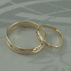 "This listing is for just the wide band. It is hand made from preformed pattern wire for the center and I've added solid 14K gold full round 18 gauge wire soldered seamlessly to each side to form an edge. This makes the band just under 5mm wide and gives it a nice comfort fit edge. I can change the color of the gold wire that edges the wide band to white gold upon request, but the center patterned area is limited to yellow gold. Your ring will be custom made to size and given a high polished fin Adjustable Gold Wedding Bands, Handmade Gold Bridal Sets For Wedding, Adjustable Gold Bands For Wedding, Wedding Rings With Intricate Design, Gold Decorative Wedding Bands, Handmade Engraved Yellow Gold Wedding Ring, Heirloom Wedding Band Adjustable, Adjustable Yellow Gold Wedding Rings, Handmade Wedding Couple Rings