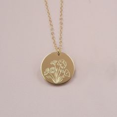 Our Wildflower necklace features a beautiful bouquet design engraved on the front, with the option to add a word, initials or a date on the back (or just keep it blank). Wildflowers are said to symbolize joy and the idea that life doesn't always have to grow according to plan to still be quite beautiful. Celebrate someone special in your life by gifting them this beautiful necklace and add a custom personalization on the back for the perfect touch. DETAILS: - 14kt gold filled or sterling silver Dainty Yellow Gold Necklaces With Engraving Option, Delicate Engraved Flower Jewelry, Gold Engraved Flower Jewelry, Engraved Gold Flower Jewelry, Birth Flower Jewelry For Anniversary, Gold Necklaces With Flower Charm For Anniversary, Gold Necklace With Flower Charm For Anniversary, Yellow Gold Flower Charm Necklace For Wedding, Delicate Engraved Necklaces For Anniversary