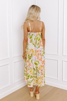 - Let your style bloom with this beautiful midi! With a flowy silhouette and a vibrant floral print, this piece will keep you looking sweet no matter where the day takes you. - Lightweight material with a colorful floral print - A built-in partial lining ending above the knee - A square cut neckline with a smocked back - Adjustable spaghetti straps - A flowy relaxed silhouette that ends in a midi length hemline Breezy Cotton Floral Print Dresses, Multicolor Floral Print Maxi Dress For Summer Outings, Multicolor Ditsy Floral Print Maxi Dress For Vacation, Pink Sundress With Vibrant Print For Spring, Pink Vibrant Print Sundress For Spring, Summer Floral Print Midi Dress For Beach Season, Breezy Floral Print Summer Dress, Breezy Summer Floral Dress, Summer Floral Midi Dress For Beach Season