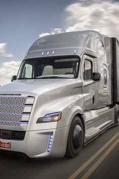 a white semi truck driving down the road