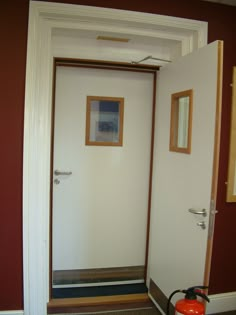 an open door leading into a room with a fire extinguisher