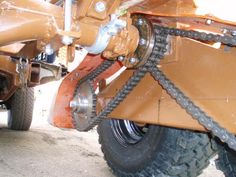 the front end of a large vehicle with chains on it's tires and wheels