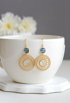 Beautiful matte gold round filigree pendants dangle from sparkly Montana blue framed glass stones. These earrings measure approx. 2.1 inches (54mm) from top to bottom. Ear wires are tarnish resistant gold plated over brass. ♥ Click the link below to see more beautiful modern earrings Gold Boho Earrings, Blue Filigree Dangle Jewelry, Elegant Blue Circular Jewelry, Jóias Body Chains, Dark Earrings, Navy Blue Earrings, Photographing Jewelry, Jewellery Photography Inspiration, Creative Jewelry Photography