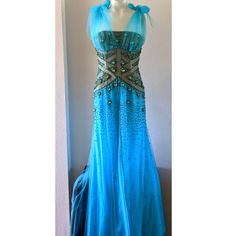 This Is A One Of A Kind Piece That Was Custom-Made And Hand-Made With Intricate Beading And A Gorgeous 1920's-1940's Style. Light Sky Blue With Bronze, Gold And Baby Blue Beading And Crystals. Taffeta Adjustable Tie-Shoulders That Attach Under The Bust To Give A Gorgeous Ruched Bust/Neckline. This Gown Is So Freaking Unique And Beautiful! Size 8, Please See Approximate Lay-Flat Measurements For Pit To Pit, Waist And Total Length. Skirt Of Dress Has Three Layers: Interior Layer Is An Opaque Polyester Blend, Middle Layer Is A Silky Feel Sheer, And The Top Layer Is An Open Layer Of The Same Material That Is Fully Lined With Beading And Has Sporadic Beading Throughout. The Bodice Is Boned Fo Fitted Blue Ball Gown, Blue Embellished Ball Gown Evening Dress, Fitted Blue Ball Gown Dress, Blue Evening Dress For Gala, Blue Formal Dress For Gala, Blue Ball Gown With Fitted Bodice, Glamorous Blue Evening Dress With Fitted Bodice, Royal Fitted Gown For Prom Season, Sleeveless Blue Evening Gown