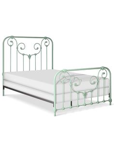 a green metal bed frame with white sheets