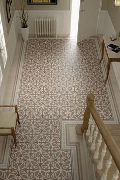 an aerial view of a hallway with stairs and tiled floors