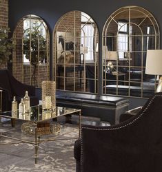 a living room filled with furniture and mirrors