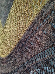 a close up view of a knitted piece of cloth with different colors and patterns