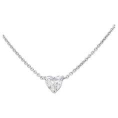 Capture love's eternal brilliance with this exquisite necklace, featuring a captivating 1 carat heart-shaped diamond. Bathed in near-colorless E color and boasting near-flawless VS1 clarity, this diamond radiates with exceptional fire and beauty, symbolizing the purest and most radiant emotions. Expertly crafted in gleaming 18K white gold, the necklace showcases the diamond's exquisite heart shape with a high-quality polish that complements its brilliance. The laser inscription on the main stone adds a touch of personalization and assurance of authenticity, making this piece a heartfelt testament to love, passion, and individuality. Metal: 18K White Gold Main stone: 1 stone Main stone carat weight: 1.00ct Shape: Heart brilliant Color grade: E Clarity grade: VS1 Cut grade: EX Dimensions: 42 Luxury Heart Cut Solitaire Necklace For Wedding, Classic White Gold Heart Necklace With Single Diamond, Classic White Gold Heart Necklace With Diamond, White Gold Heart Necklace With Single Diamond, White Heart Cut Diamond Necklace, Heart Cut Diamond Solitaire Necklace In Fine Jewelry Style, White Brilliant Cut Heart Necklace In Fine Jewelry Style, Fine Jewelry Heart Cut Solitaire Necklace, Heart Cut Single Diamond Anniversary Necklace