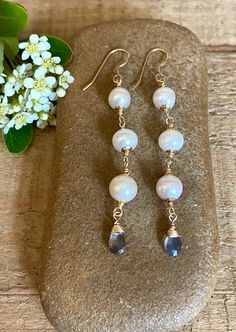 Gold filled dangle earrings with white freshwater pearls and faceted labradorite gemstones Briolette Pearl Jewelry With Natural Stones, Pearl Briolette Earrings, Natural Stone Dangle Pearl Earrings, White 14k Gold Filled Drop Jewelry, White Briolette Pearl Drop Earrings, White Pearl Earrings With Natural Stones, Handmade Briolette Pearl Earrings, White Pearl Earrings With Natural Stones For Wedding, White Natural Stone Pearl Earrings For Wedding