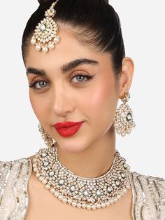 This jewellery set consists of a necklace, a pair of earrings and a maang tikkaGold-plated Gold-Toned choker necklace has white kundan-studded beaded detailsSecured with a drawstring closureA pair of matching drop earrings, each secured with a post-and-back closureA matching maang tikka, secured with a hook closure Size & Fit Necklace Length-39 cmEarring Length-7 cmMaangtikka Length-18 cm Material & Care Material: AlloyPlating: Gold-platedStone type: Kundan Care InstructionsWipe your jewellery with a soft cloth after every useAlways store your jewellery in a flat box to avoid accidental scratchesKeep sprays and perfumes away from your jewelleryDo not soak your jewellery in water Dispatch within 7 days White Kundan Jewelry Sets, White Kundan Necklace With Mirror Work For Party, White Kundan Beaded Jewelry Sets, White Kundan Necklace With Mirror Work For Eid, White Beaded Kundan Jewelry Sets, White Jewelry Sets With Mirror Work For Festivals, White Necklace With Mirror Work For Festive Season, White Bridal Necklace With Mirror Work For Diwali, Festive White Necklace With Mirror Work