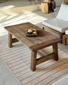 a wooden table sitting on top of a white rug